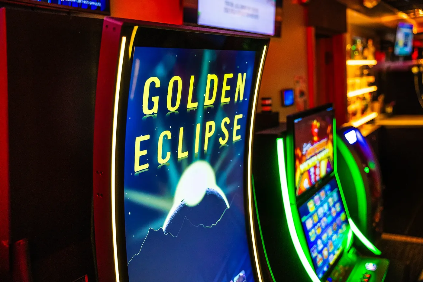 Golden Eclipse cabinet beside other gaming machines in a venue