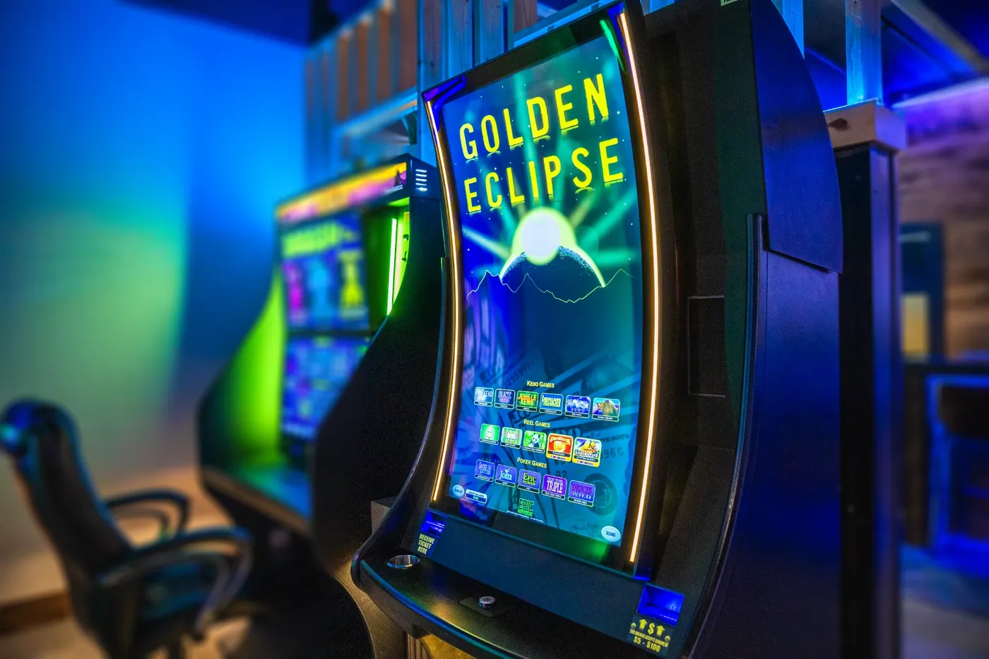 Golden Eclipse gaming cabinet in a dimly lit gaming room
